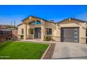 Inviting home with manicured lawn, covered entrance, and modern garage door at 2638 E Edgemont Ave, Phoenix, AZ 85008