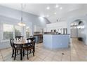 Open kitchen area with stainless appliances, breakfast nook, island, and lots of natural light at 2922 E Encanto St, Mesa, AZ 85213