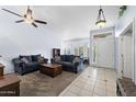 Bright living room features neutral paint, tiled entry, vaulted ceilings, and plush sofas at 2922 E Encanto St, Mesa, AZ 85213