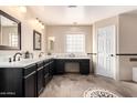 Luxurious primary bathroom boasts double sinks, sleek cabinetry, and a decorative tile floor pattern at 2977 E Teakwood Pl, Chandler, AZ 85249