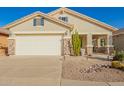 Inviting home with neutral stucco, river rock accents, desert landscaping and a 2 car garage at 30153 N Gecko Trl, San Tan Valley, AZ 85143