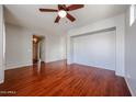 Unfurnished living room with hardwood floors, gray walls, and a ceiling fan at 34705 N 26Th Ave, Phoenix, AZ 85086