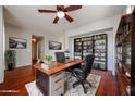 Cozy home office with hardwood floors, built-in bookshelves, and a comfortable executive chair at 34705 N 26Th Ave, Phoenix, AZ 85086