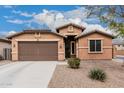 Charming single-story home with a two-car garage and low-maintenance desert landscaping at 38062 W San Capistrano Ave, Maricopa, AZ 85138