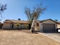 Charming single-story home featuring a unique arched entryway and low maintenance desert landscaping at 4101 E Nancy Ln, Phoenix, AZ 85042