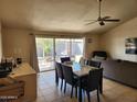 Inviting living room featuring tiled floors, neutral walls, ceiling fan, and a cozy seating area at 4101 E Nancy Ln, Phoenix, AZ 85042