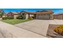 Expansive driveway leading to a two-car garage, complemented by well-maintained landscaping at 4109 E Del Rio St, Gilbert, AZ 85295
