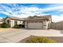 View of the home's exterior, showcasing a spacious driveway and a two-car garage in a well-kept neighborhood at 4109 E Del Rio St, Gilbert, AZ 85295