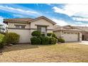 The front yard has mature shrubbery and trees with a nice lawn, with the house in the background at 4109 E Del Rio St, Gilbert, AZ 85295