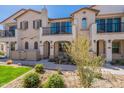 Inviting two-story townhome with landscaped front yard and cozy porch seating at 4655 S Glacier --, Mesa, AZ 85212