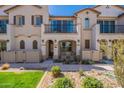 Inviting two-story townhome with landscaped front yard and cozy porch seating at 4655 S Glacier --, Mesa, AZ 85212