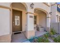 Inviting front porch with comfortable seating and arched entryway at 4655 S Glacier --, Mesa, AZ 85212