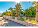 Welcoming home framed by a decorative fence, mature landscaping, and vibrant trees at 4747 W Sunnyside Ave, Glendale, AZ 85304