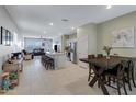 Open-concept kitchen and dining area with stainless steel appliances and ample natural light at 47737 W Coe St, Maricopa, AZ 85139