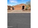 Charming single-story home with a desert-style landscaped front yard and a two-car garage at 528 E Wolf Hollow Dr, Casa Grande, AZ 85122