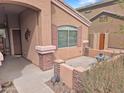 Cozy front patio with brick accents, a small seating area, and desert landscaping at 528 E Wolf Hollow Dr, Casa Grande, AZ 85122