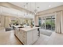 Bright kitchen island with a sink, bar seating, and stainless steel dishwasher at 5411 E Duane Ln, Cave Creek, AZ 85331