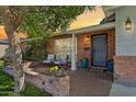 Inviting front porch with brick accents, comfortable seating, and vibrant potted flowers for a welcoming ambiance at 5529 N 19Th St, Phoenix, AZ 85016