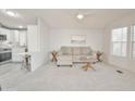 Bright living room featuring neutral tones, plush carpet, and plenty of natural light at 5735 E Mcdowell Rd # 197, Mesa, AZ 85215