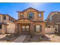 Charming two-story home featuring desert landscaping and a well-manicured lawn at 5828 E Hoover Ave, Mesa, AZ 85206