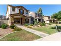 Charming two-story home featuring a stucco exterior, brown shutters, and a well-maintained landscaped front yard at 5828 E Hoover Ave, Mesa, AZ 85206