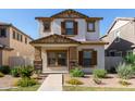 Charming two-story home featuring a stucco exterior, brown shutters, and a well-maintained landscaped front yard at 5828 E Hoover Ave, Mesa, AZ 85206