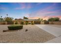 Charming single-story home featuring desert landscaping, a spacious driveway, and a two-car garage at 6309 E Crocus Dr, Scottsdale, AZ 85254