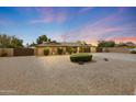 Inviting single-story home with desert landscaping, neutral paint, and a spacious two-car garage at 6309 E Crocus Dr, Scottsdale, AZ 85254