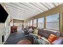 Relaxing sunroom with comfortable seating, a table, and abundant natural light through screened windows at 8600 E Broadway Rd # 150, Mesa, AZ 85208