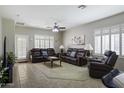 Inviting living room with neutral colors, tile floors, a ceiling fan, and bright shuttered windows at 9149 E Auburn St, Mesa, AZ 85207