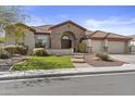 Charming home with a stone facade, arched entryway, three-car garage and desert landscaping at 9161 W Bajada Rd, Peoria, AZ 85383