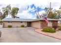 Spacious single-story home with a long driveway and well-maintained desert landscaping at 11612 S 51St St, Phoenix, AZ 85044