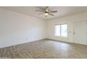 Bright, open living room with wood-look flooring, neutral paint, and natural light at 11666 N 28Th Dr # 196, Phoenix, AZ 85029