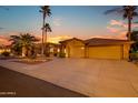 Home with a long driveway leading to a 3-car garage, and lush landscaping at 15751 W Linksview Dr, Surprise, AZ 85374