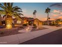 Charming single Gathering home featuring manicured front yard, desert landscaping and a circular driveway at 15751 W Linksview Dr, Surprise, AZ 85374