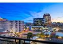 Balcony view overlooking the city skyline with parking and bright city lights at dusk at 16 W Encanto Blvd # 616, Phoenix, AZ 85003