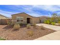 Inviting single-story home featuring a well-manicured front yard and a two car garage at 18449 E Eloisa Dr, Gold Canyon, AZ 85118