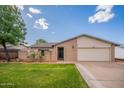 Well-maintained single-Gathering home with a cozy front yard and brick accents at 2317 E Concorda Dr, Tempe, AZ 85282