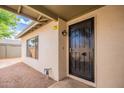 Inviting front entry with a black security door, a small window and neutral stucco exterior at 2317 E Concorda Dr, Tempe, AZ 85282