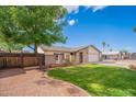 A beautifully landscaped front yard, with mature tree, leading to a charming single-Gathering home at 2317 E Concorda Dr, Tempe, AZ 85282