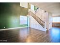 Bright room with high ceilings, decorative staircase, and modern flooring at 35210 N 34Th Ln, Phoenix, AZ 85086