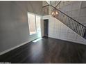 Bright living room boasts high ceilings, dark wood floors, and modern staircase with beautiful metal railings at 35210 N 34Th Ln, Phoenix, AZ 85086