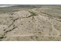 Overhead angle showcasing desert landscape with sparse vegetation and winding dirt roads on a clear day at 385 W Vineyard Rd # C, Tonopah, AZ 85354