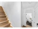 Bright staircase with wood steps and LED lighting, leading to a hallway and bedroom at 4220 N 32Nd St # 5, Phoenix, AZ 85018