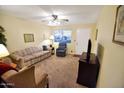 Comfortable living room with carpet flooring, neutral walls, and plenty of natural light at 4328 E Capri Ave # 171, Mesa, AZ 85206