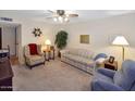 Cozy living room featuring neutral carpet, comfortable seating, and warm, inviting light fixtures at 4328 E Capri Ave # 171, Mesa, AZ 85206