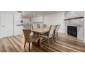 Dining room with hardwood floors, stylish chairs, and a view into a modern kitchen at 4720 E Adobe Dr, Phoenix, AZ 85050