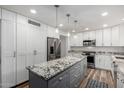 Spacious kitchen island with sleek stainless steel appliances and white subway tile backsplash at 4720 E Adobe Dr, Phoenix, AZ 85050