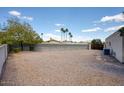 Large, low-maintenance backyard with gravel landscaping and mature trees offering shade at 536 W Surrey Ave, Phoenix, AZ 85029