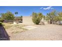 Spacious backyard featuring a covered patio and a barbecue area, perfect for outdoor entertaining at 536 W Surrey Ave, Phoenix, AZ 85029
